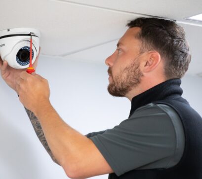 Technician installing security install